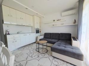a living room with a couch and a table at Siyana Obzor in Obzor
