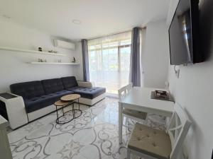 a living room with a couch and a table at Siyana Obzor in Obzor