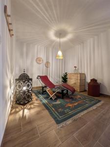 a living room with a red chair and a rug at Casas da Lola - Mourão in Mourão