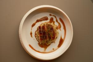 a white plate with food on a table at Hotel Mühlbacherhof in Lagundo +47 photos
