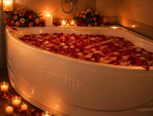 a bath tub filled with flowers and candles at Lavender SaPa Hotel & Spa Right in the center of Sa Pa - Free foot soak service in Lao Cai +93 photos