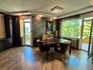 a dining room with a table and chairs at La Zur Guest House in Ravda