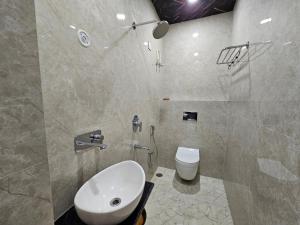 a bathroom with a sink and a toilet at Royal Rani Residency in Ayodhya +18 photos