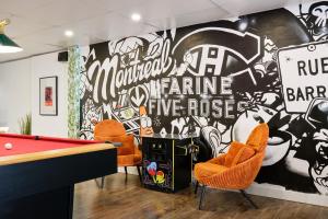 a room with a pool table and a wall with graffiti at MtlVacationRentals - The Entertainer in Montreal