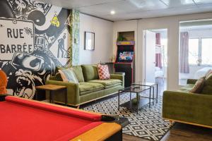 a living room with couches and a pool table at MtlVacationRentals - The Entertainer in Montreal +20 photos