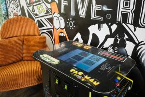 a video game system in a room with a chair at MtlVacationRentals - The Entertainer in Montreal