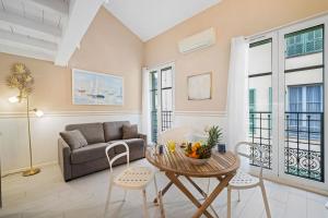 a living room with a couch and a table at VILLA CARLA appartement central zone piétonne clim in Menton