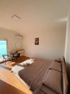 a bedroom with a large bed and a table at Indijano Apartment in Ohrid