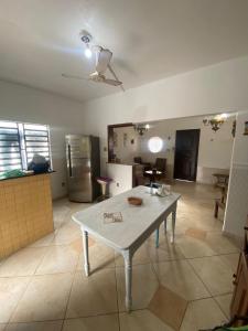 a kitchen with a table in the middle of a room at Casa Salinas em Salinópolis PA - Completa in Salinópolis