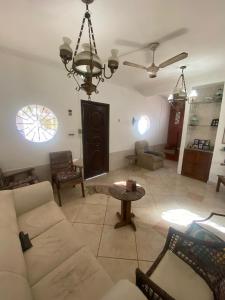 a living room with a couch and a table at Casa Salinas em Salinópolis PA - Completa in Salinópolis