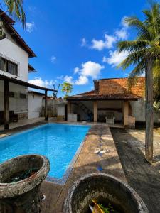 a swimming pool in front of a house at Casa Salinas em Salinópolis PA - Completa in Salinópolis