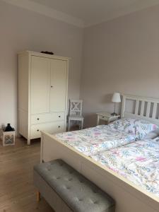 a bedroom with a large bed and a dresser at Apartment Am Gondelteich in Bad Elster