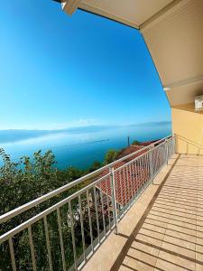 a balcony of a house with a view of the ocean at Indijano Apartment in Ohrid
