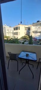 a table and a chair on a balcony at Aleka Apartment in Kos