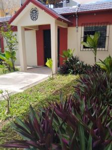 a small house with a red and white at Casa León in Bacalar