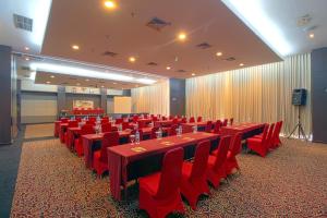 a conference room with red tables and red chairs at Bela International Hotel & ConventionTernate in Ternate