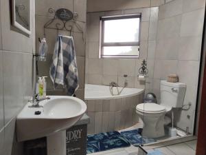 a bathroom with a sink and a toilet and a tub at Vinknes in Boknes +15 photos