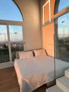 a bedroom with a bed and a large window at The Tower Roma in Rome