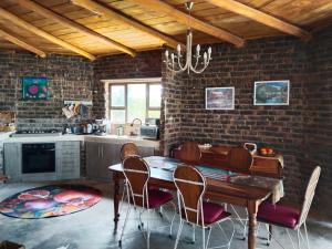 a kitchen with a table and chairs in a room at Vinknes in Boknes