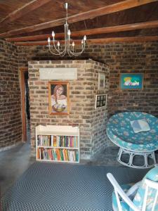 a doll house with a table and a book shelf at Vinknes in Boknes