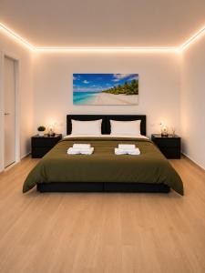 a bedroom with a large bed with two night stands at Oasis Apartments & Rooms in Plakias +59 photos