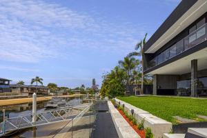 a building with a walkway next to a body of water at Urban Hideaway - Stay 4 Pay 3 in Gold Coast