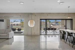 a living room with a couch and a table at Urban Hideaway - Stay 4 Pay 3 in Gold Coast