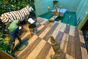 a deck with a zebra and a bench and a pool at Motel Venus Madrid Norte in Meco