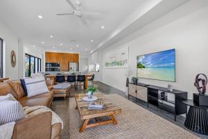 a living room with a couch and a table at Wanderlust heated pool rooftop deck in Gold Coast