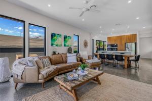 a living room with a couch and a table at Wanderlust heated pool rooftop deck in Gold Coast