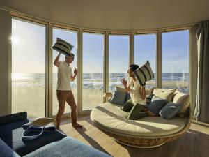 a man and woman standing in a room with a bed at Novotel Thalassa Le Touquet in Le Touquet-Paris-Plage