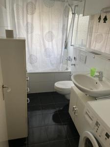 a white bathroom with a toilet and a sink at Apartmenthaus in der Nähe Wolfsburg und VW in Oebisfelde