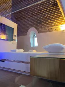 a bedroom with a bed and a brick wall at The Tower Roma in Rome +29 photos