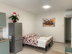 a small room with a bed and a refrigerator at Riposati e Riparti in San Piero a Sieve +8 photos
