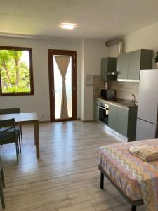 a kitchen and dining room with a table and a refrigerator at Riposati e Riparti in San Piero a Sieve