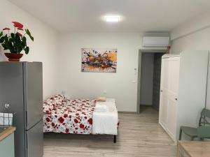 a bedroom with a bed and a painting on the wall at Riposati e Riparti in San Piero a Sieve