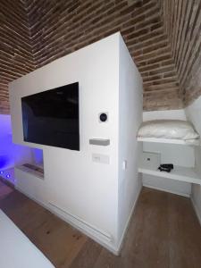 a white wall with a flat screen tv on it at The Tower Roma in Rome