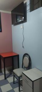 a room with a table and a chair and a desk at Hospedaje LA RESIDENCIA in Ayacucho