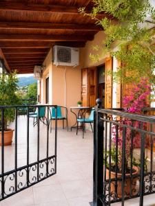 a balcony of a house with a table and chairs at Epavlis Elena in Konitsa