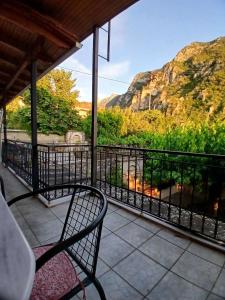a screened porch with a view of a mountain at Epavlis Elena in Konitsa +5 photos