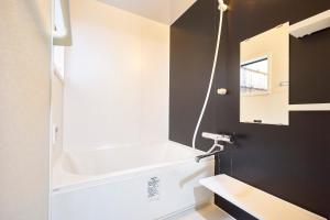 a bathroom with a tub and a sink and a mirror at Kyoyado Hakuto in Kyoto +16 photos
