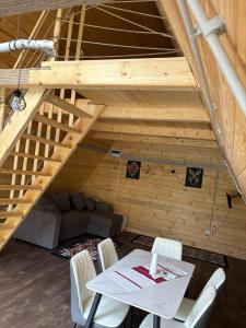 a room with a table and chairs and a couch at Complex turistic Casa Diaconu in Breaza