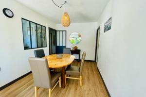 a dining room with a wooden table and chairs at Spacious cocoon with pool in La Rochelle in La Rochelle