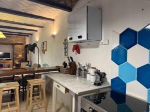 a kitchen with blue and white tiles on the wall at Casa Vigneto - Villa With Pool in Toano