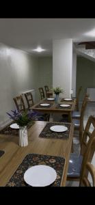 a dining room with wooden tables and chairs at Hotel Santal in Bukhara +18 photos