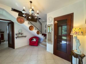 a hallway with a staircase and a chandelier at Casa Vigneto - Villa With Pool in Toano +29 photos