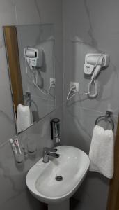 a bathroom with a sink and a mirror at Hotel Santal in Bukhara
