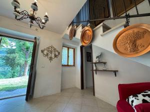 a living room with a red couch and a window at Casa Vigneto - Villa With Pool in Toano