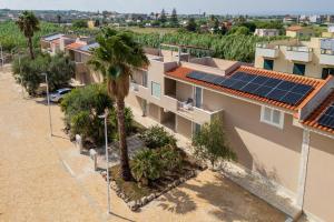 an aerial view of houses with solar panels on their roofs at Sea Residence LUNA ROSSA in Marzamemi
