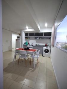 a kitchen with a table and chairs in a room at Dptos CipoTerra in Cipolletti